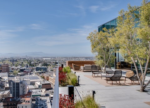 a terrace with tables and chairs overlooking the city