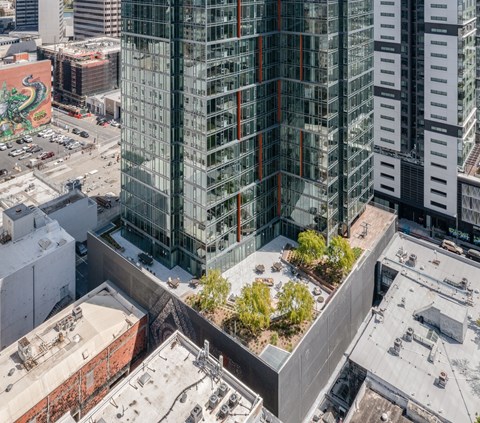 an aerial view of a tall building with trees on top of it