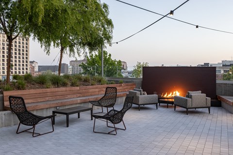 an outdoor patio with chairs and a fire pit