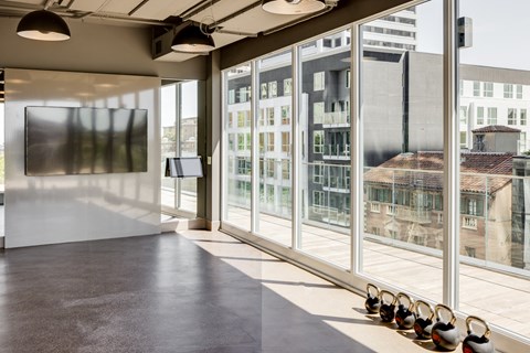 a row of shoes on the floor in front of a large window