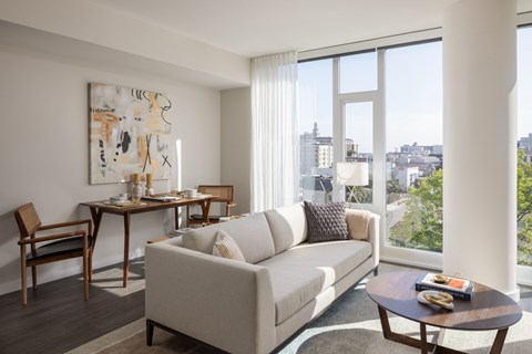 a living room with a couch and a table and a large window