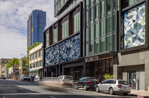 a city street with cars parked in front of a building