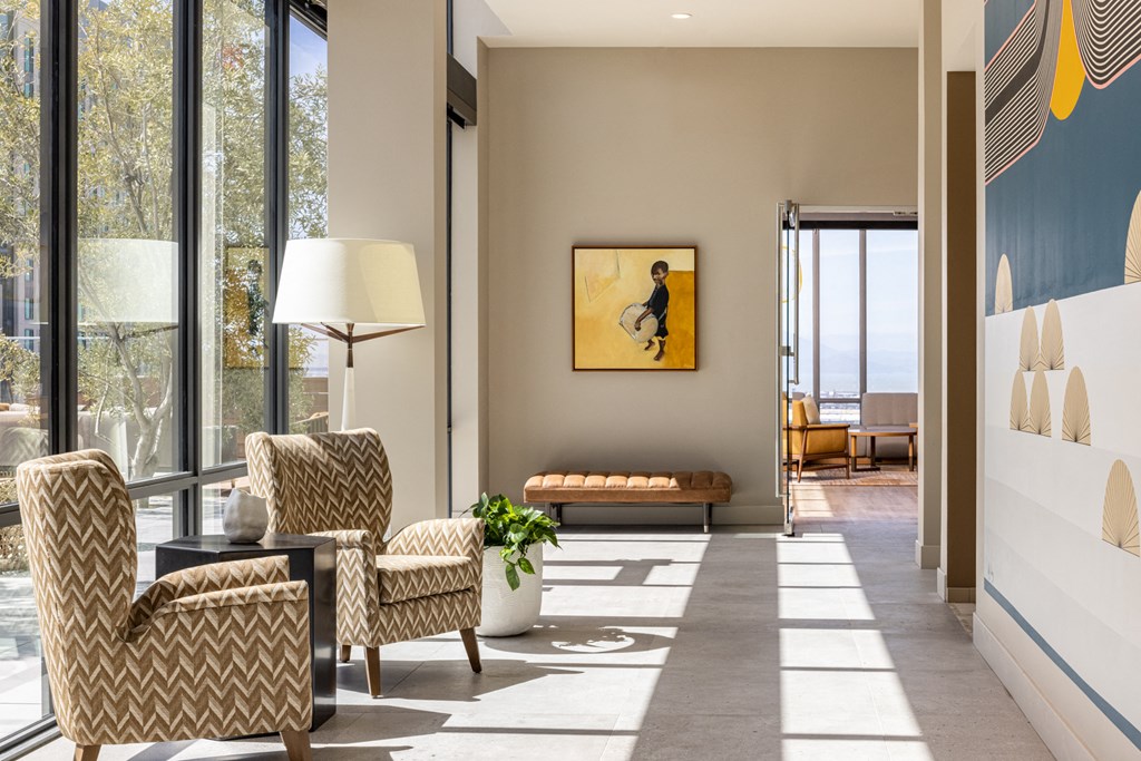 a living room with two chairs and a table and a large window