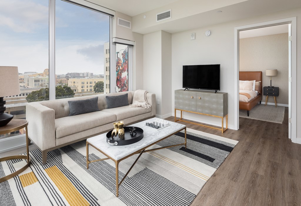 a living room with a couch and a coffee table and a television