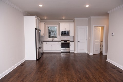 a kitchen with white cabinets and stainless steel appliances