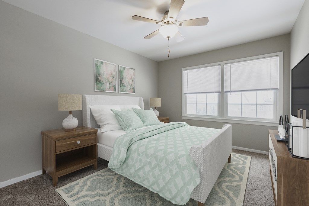 a bedroom with a bed and a ceiling fan