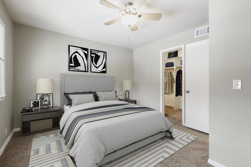a bedroom with a bed and a ceiling fan