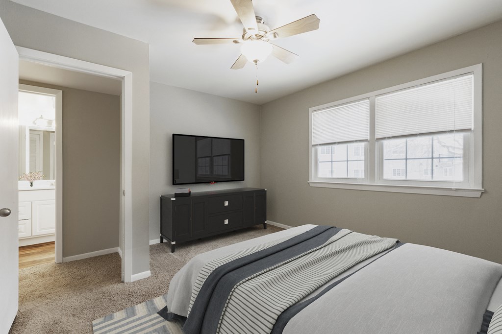 a bedroom with a large bed and a ceiling fan