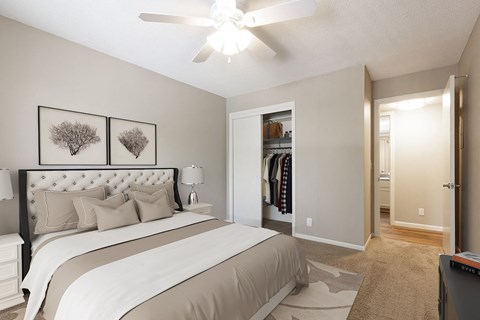 a bedroom with a large bed and a ceiling fan