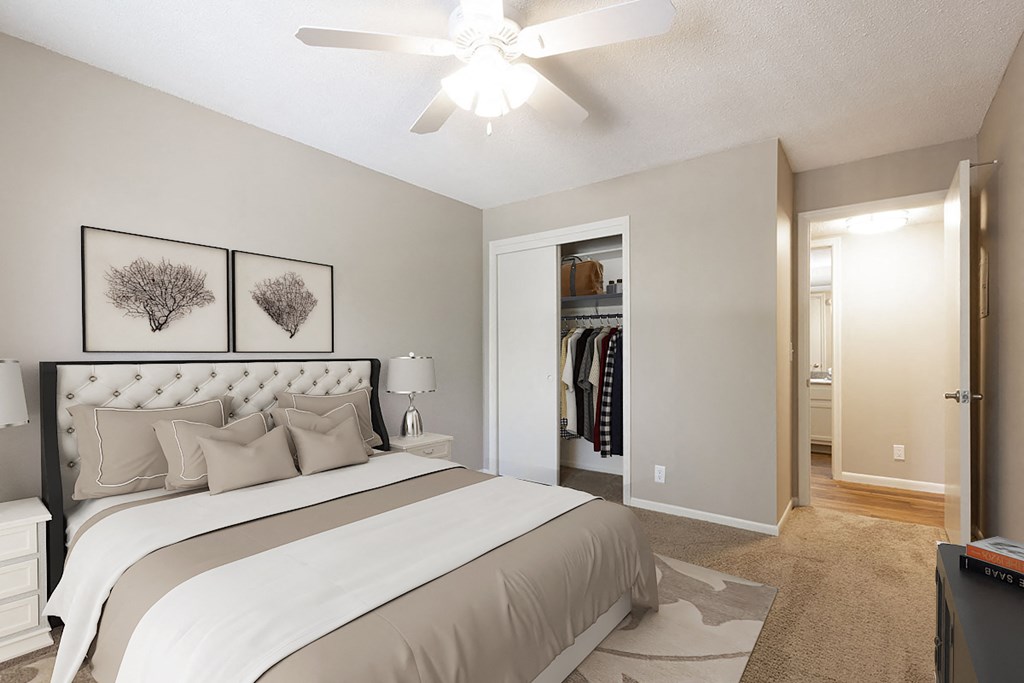 a bedroom with a large bed and a ceiling fan