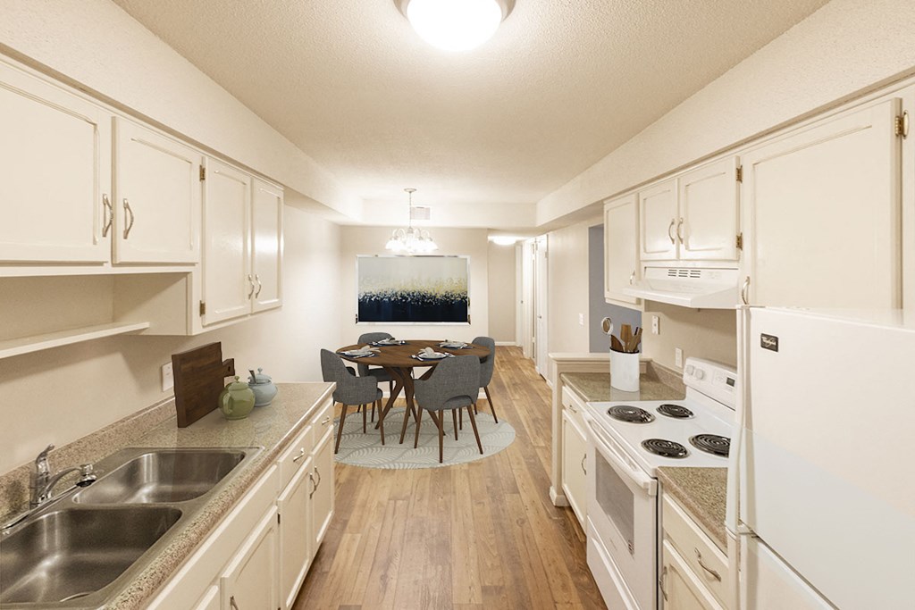 a kitchen and dining room with white cabinets and a table and chairs