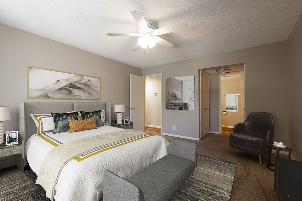 a bedroom with a large bed and a ceiling fan