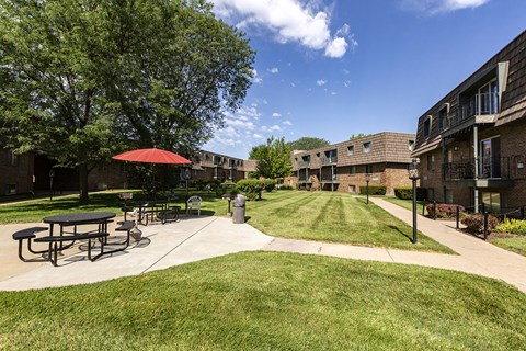 our apartments have a spacious courtyard with a picnic table and umbrella