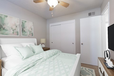a bedroom with a bed and a ceiling fan