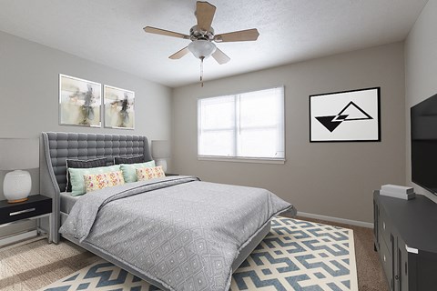 an attic bedroom with a bed and a ceiling fan