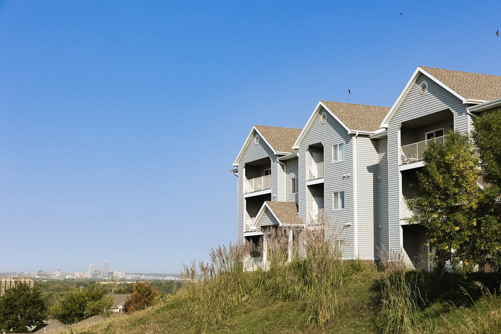A row of houses with a blue sky above them.
