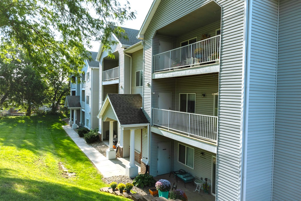 Apartment complex with balconies and green lawns.