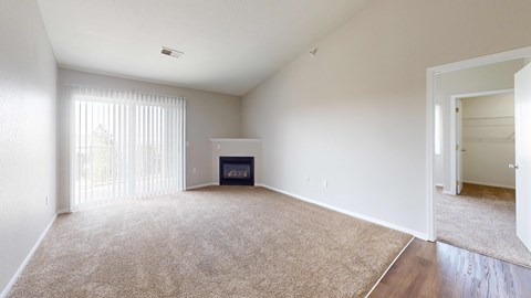 A living room with a fireplace and a carpet.