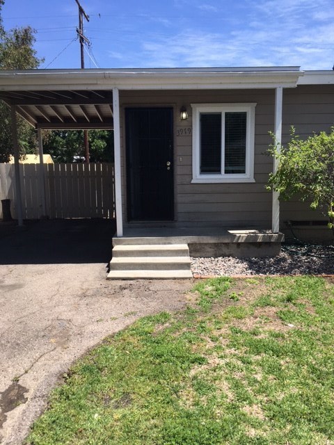 a small house with a porch and a driveway