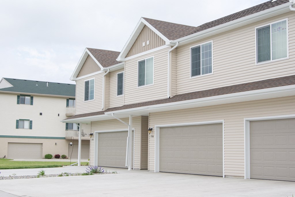a house with two garage doors on the side of it