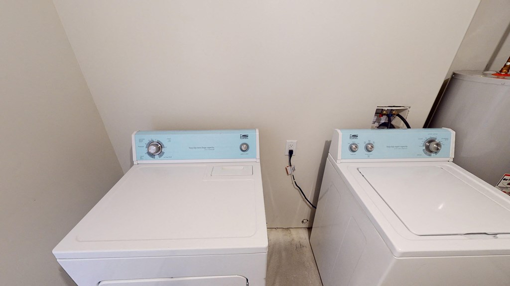 two washing machines in the laundry room of a home