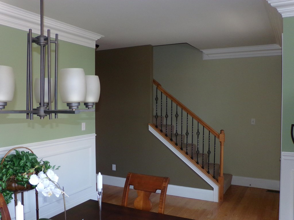 a dining room with a table and a staircase