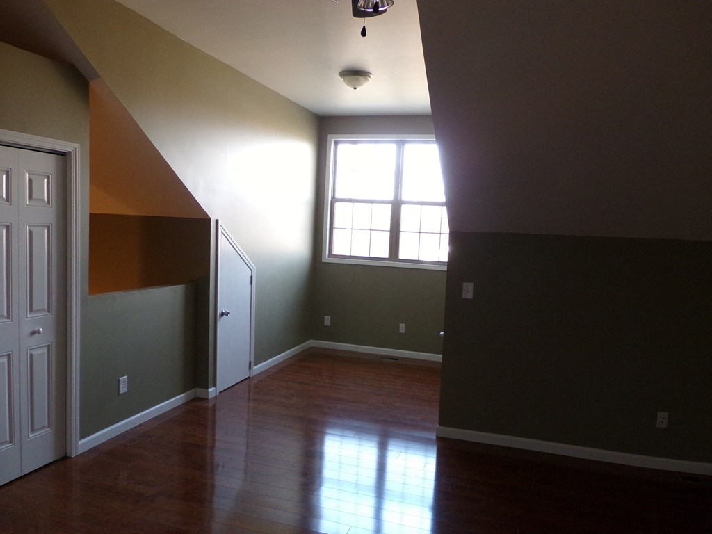 an empty living room with a window and a door