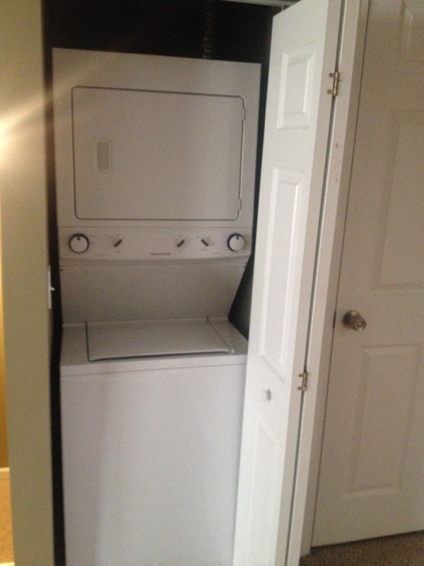 a white washer and dryer in a closet