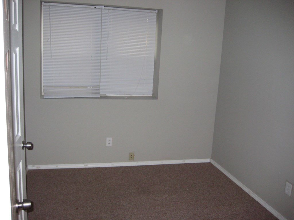 a room with a window and a carpet