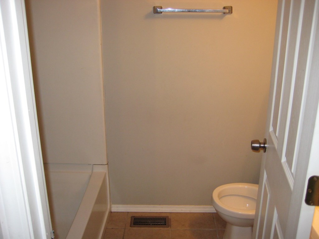 a small bathroom with a toilet and a shower