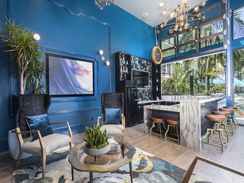 A blue living room with a white chair and a coffee table.