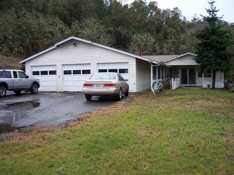 A house with a car parked in front of it.
