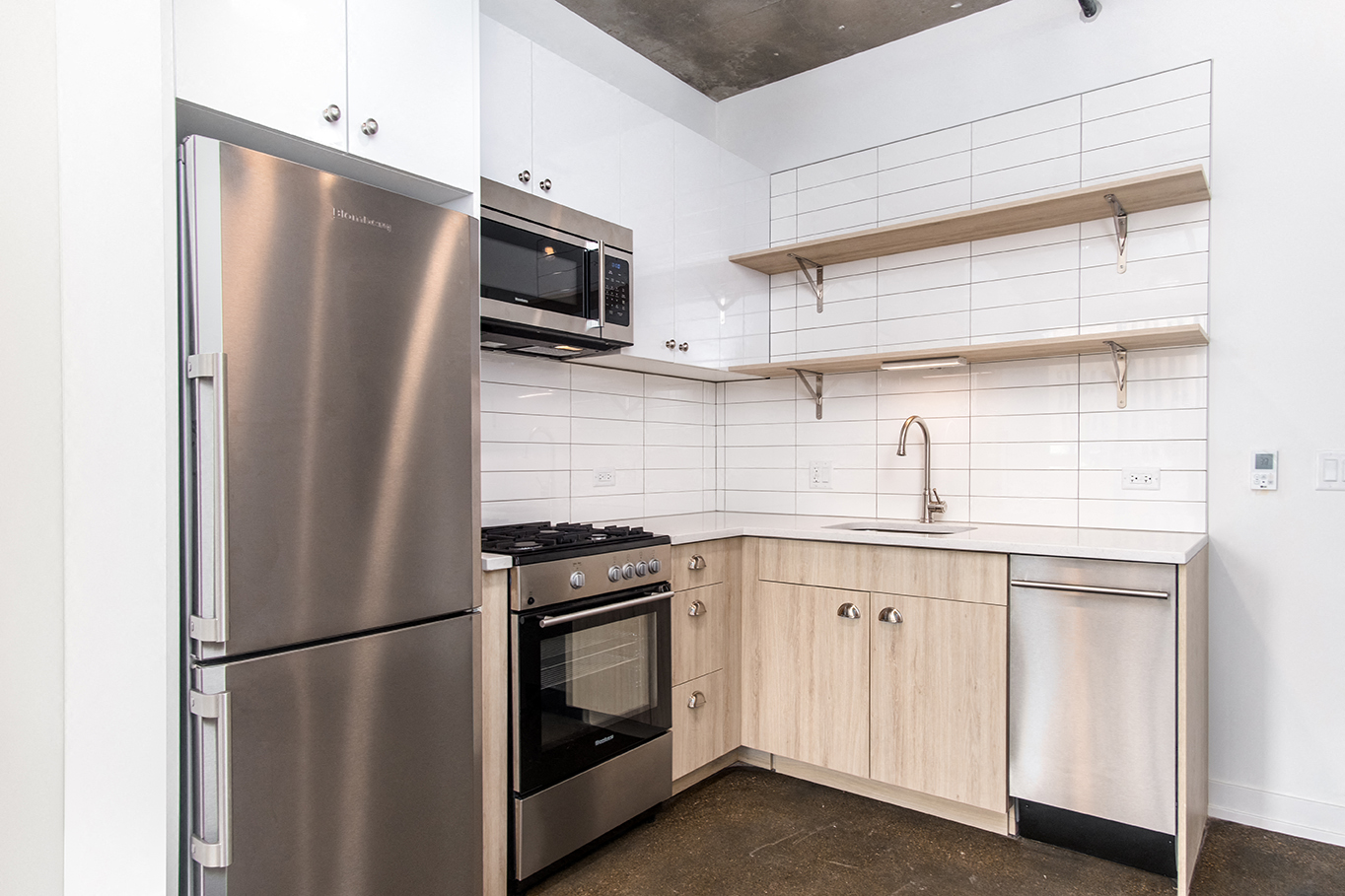 a kitchen with wooden cabinets and stainless steel appliances