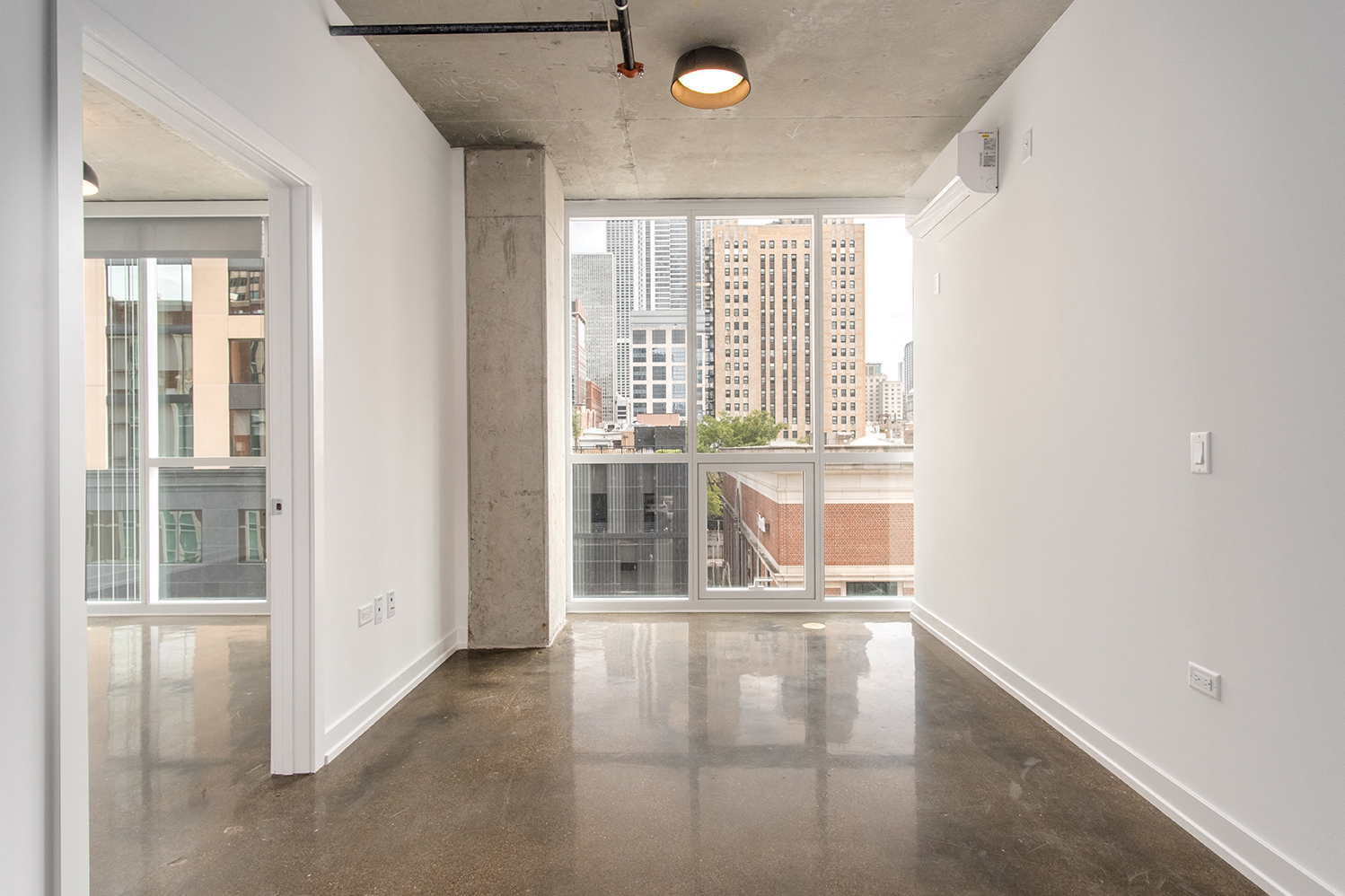 an empty living room with a view of the city