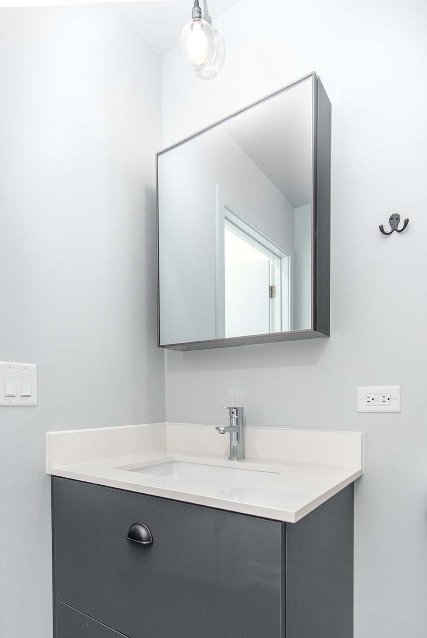 a small bathroom with a sink and a mirror