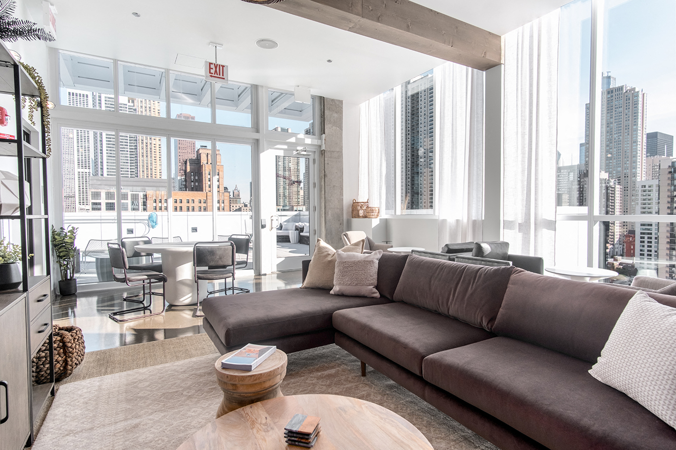a living room with a brown couch and a large window
