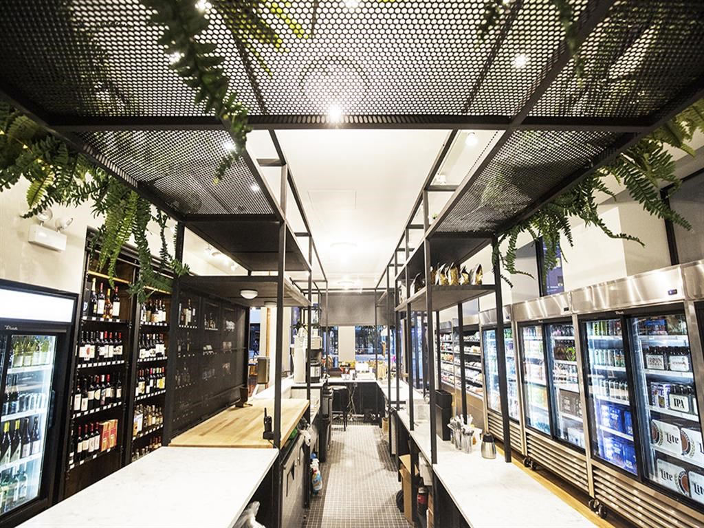the interior of a restaurant with wine shelves and a bar