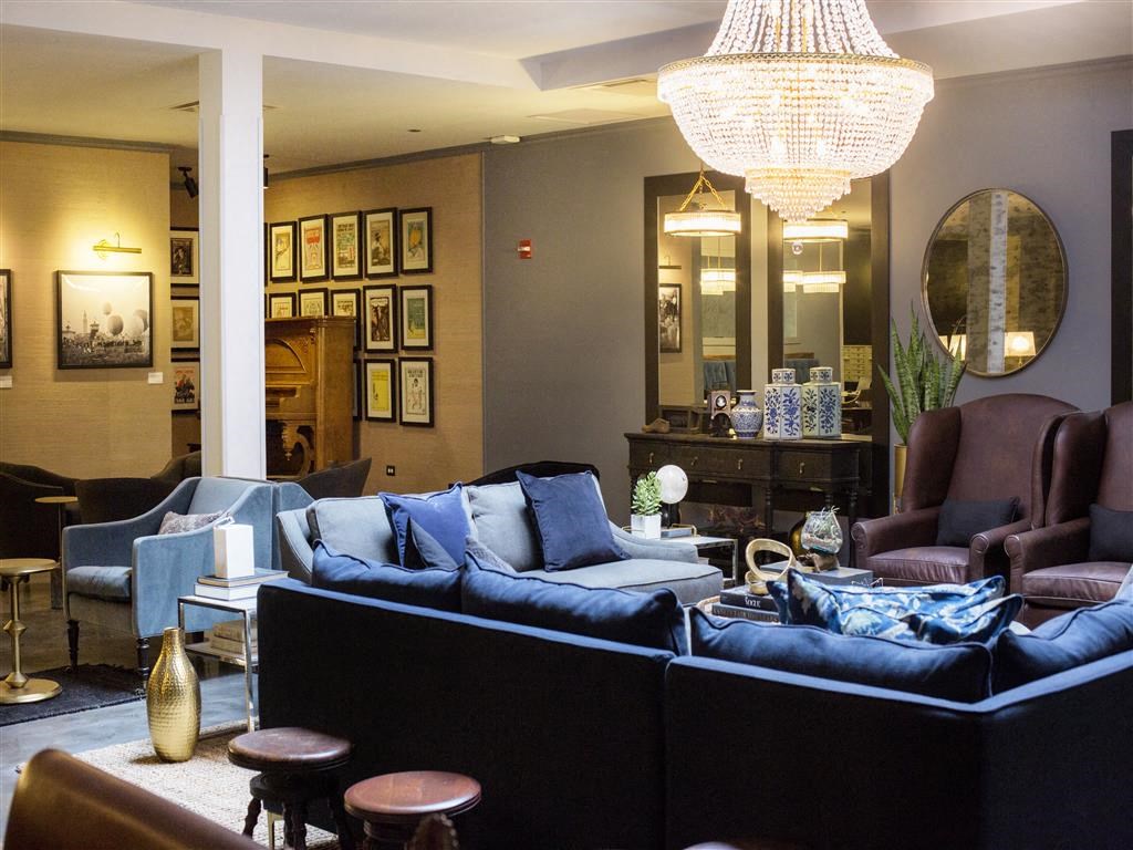 a living room filled with furniture and a chandelier