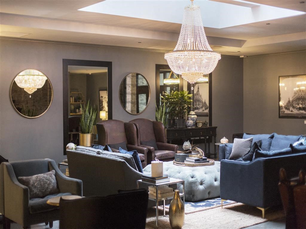 a living room filled with furniture and a chandelier