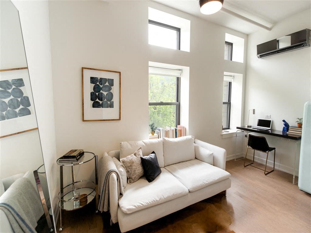 a living room with a couch in front of a window