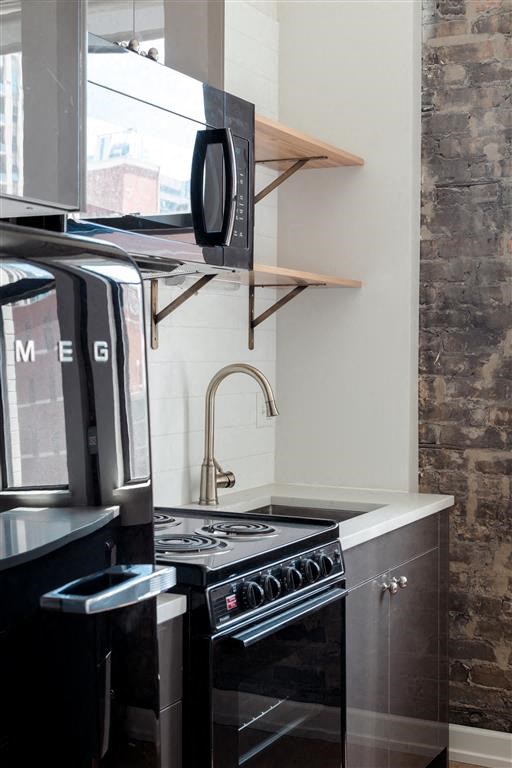 a small kitchen with a stove and a microwave