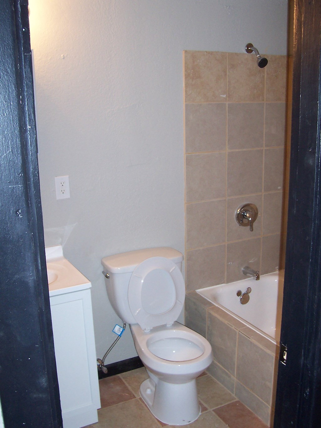 a bathroom with a toilet and a tub and a sink