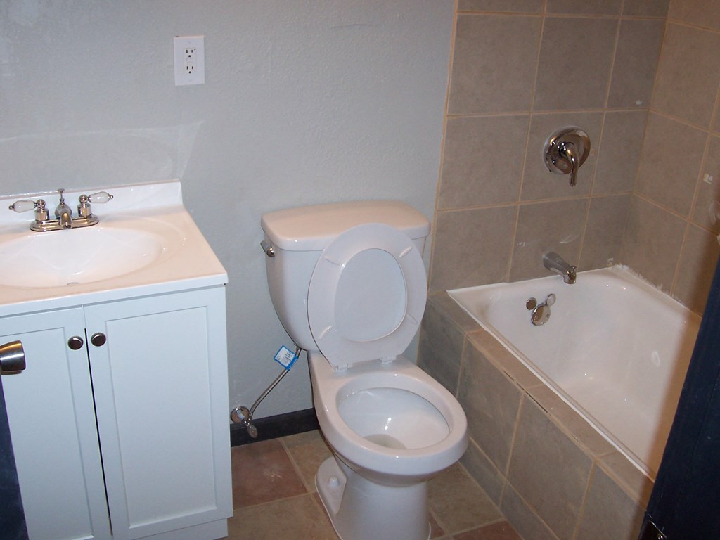 a bathroom with a sink toilet and bath tub