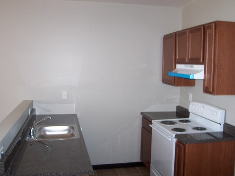 A small kitchen with a stove and sink.