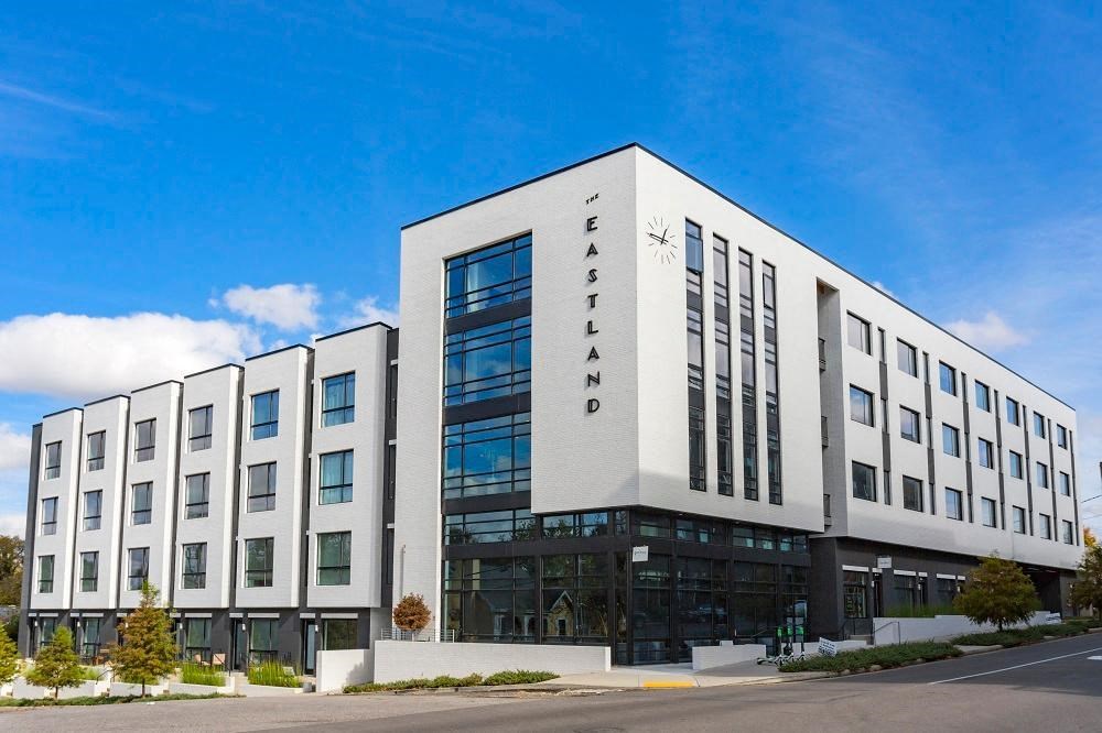 a large office building with a blue sky in the background