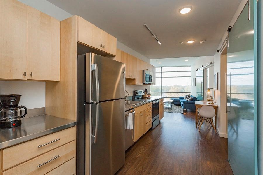 a large kitchen with a stainless steel refrigerator