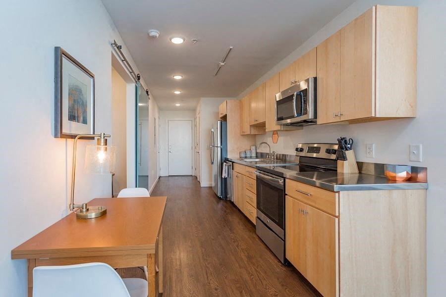 a kitchen with a stove and a microwave and a table