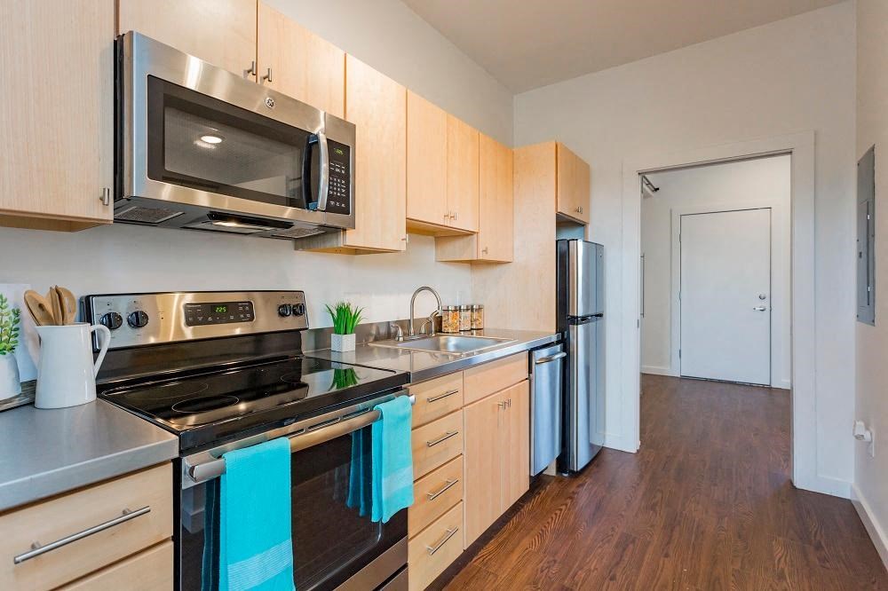 a kitchen with stainless steel appliances and wooden cabinets