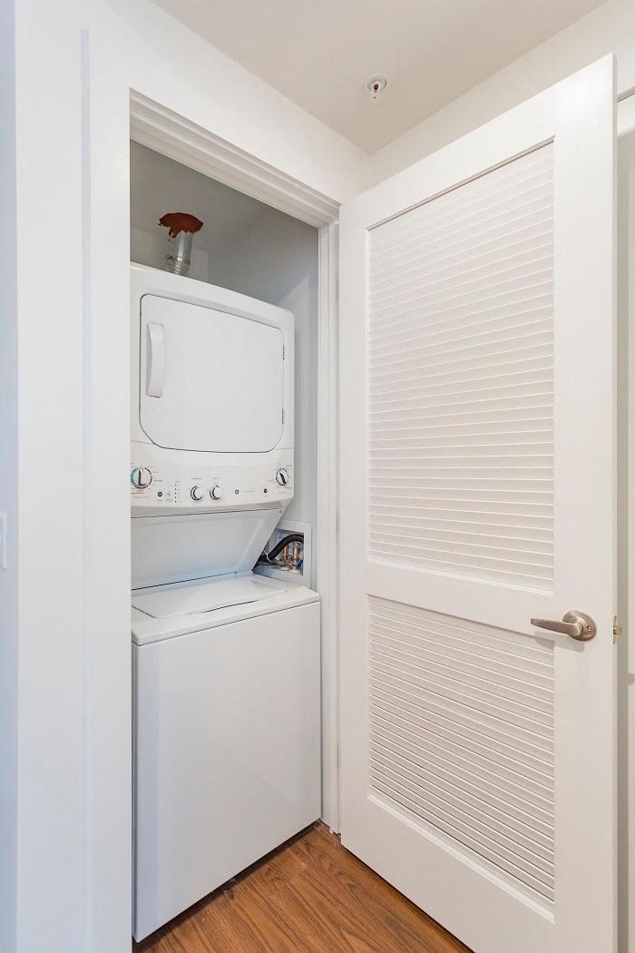 a small closet with a washer and dryer in it