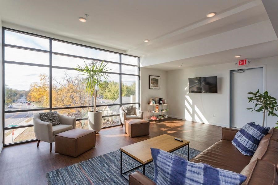 a living room with a couch and chairs and a television